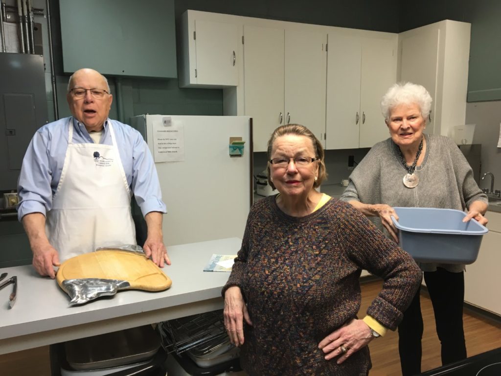 Tom, Diane, and Peg preparing food